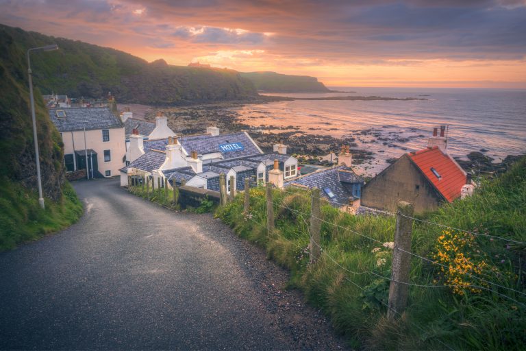 Street view at sunset of Pennan Cottages